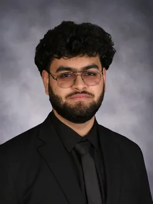 Karan Kapur, head and shoulders, in a black suit.